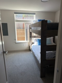 Bunk-bed room — beds made and carpet vacuumed.