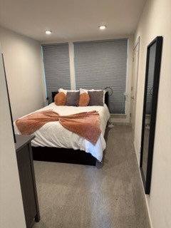 Bedroom with fresh bedding and dust-free mirrors.